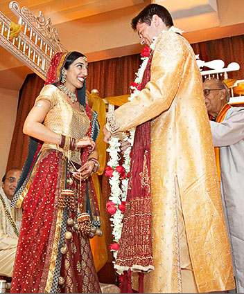 red bridal lehenga  and golden groom sherwani