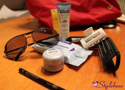stuff in handbag , goggles, cream , tissue,comb, mirror,sun screen, lip gloss, face wash