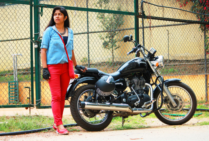 Biker girl in red jeans and blue shirt