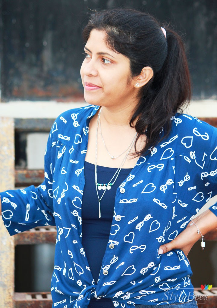 Printed blue shirt with layered necklace
